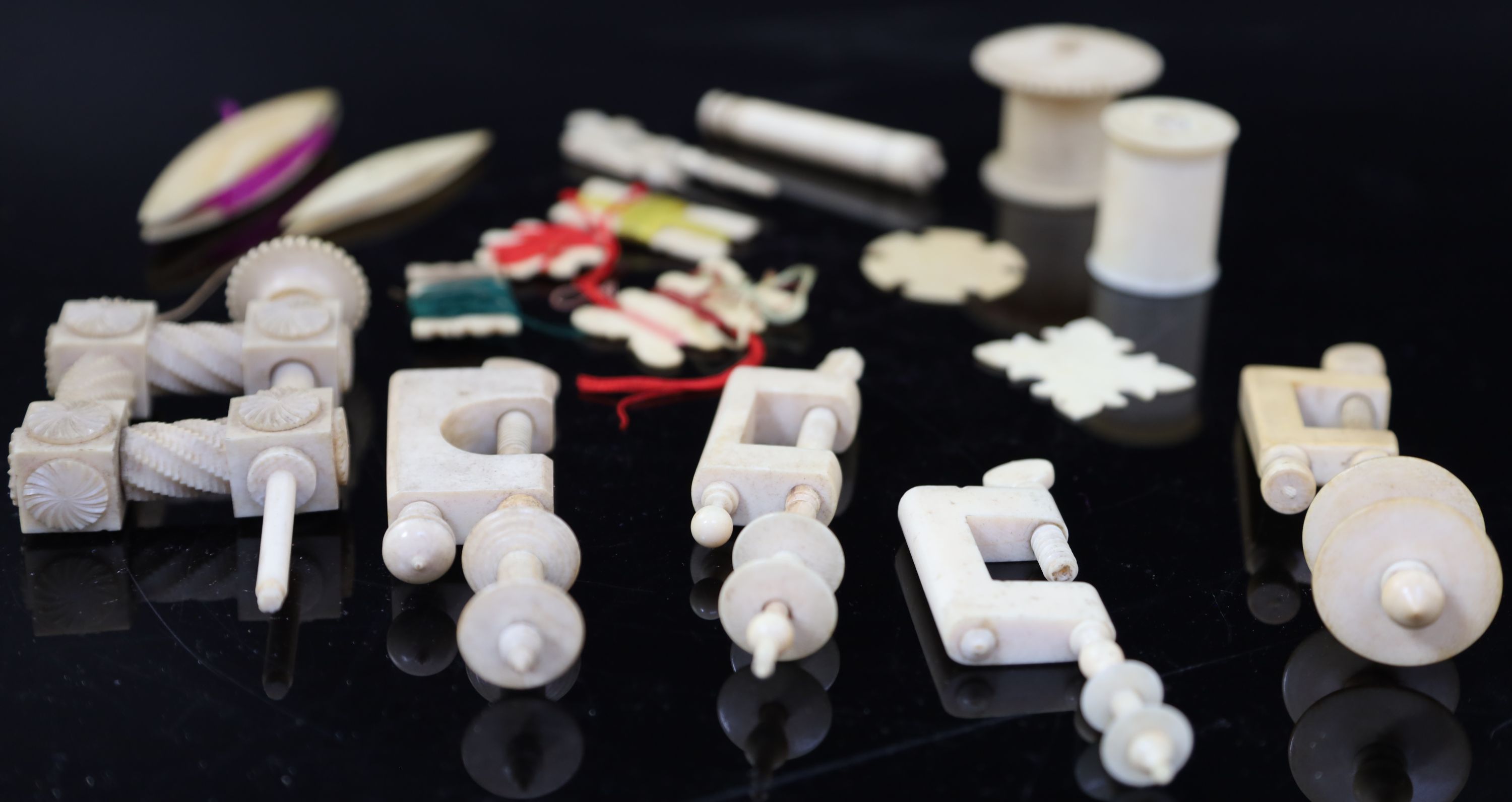 A collection of assorted early 19th century and later ivory sewing accessories